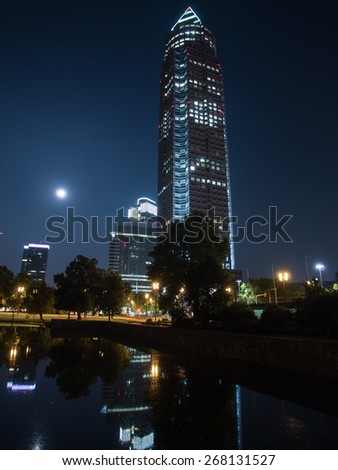 In the exhibition site: Trade Fair Tower, Messeturm, and full moon in Frankfurt, Germany