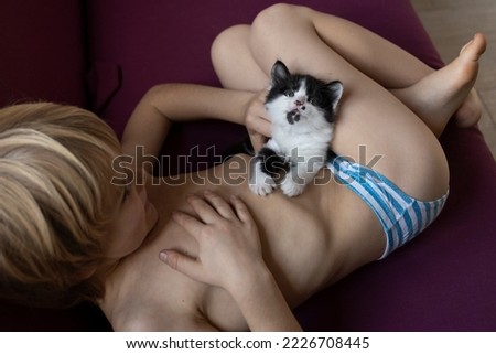 Similar – Image, Stock Photo Little boy and cat taking selfie with mobile phone on bed