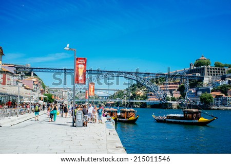 PORTO, PORTUGAL - AUGUST 6: Tourists walk along Douro river in Porto, Portugal, on August 6th, 2014. Porto city centre is registered as a World Heritage Site by UNESCO since 1996.