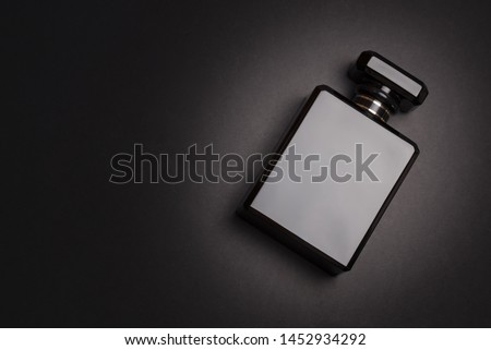  Perfume bottle. Mockup on dark or black empty background. Fragrance for man or woman. Top view. Horizontal photo with copy space 
