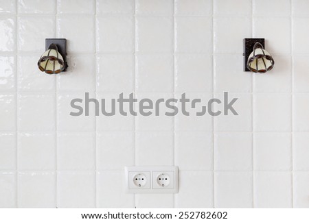 kitchen, a fragment of a wall of white tiles, sconce