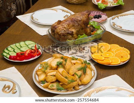 holiday table with grilled chicken with fries and vegetables