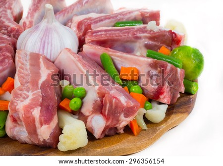 raw meat and frozen vegetables on a tray. cooking delicacies. White background. isolated