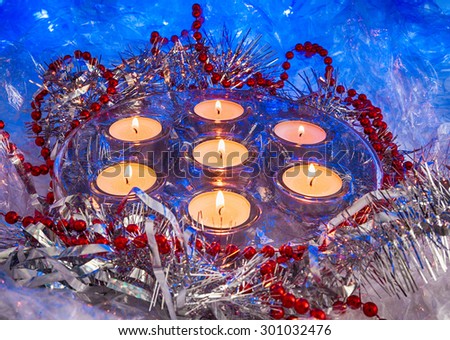 holiday candles, candle holder, Christmas toys on a blue background. celebration. Photo in old image style. colored lights, stylized graphics, holiday card, wallpaper