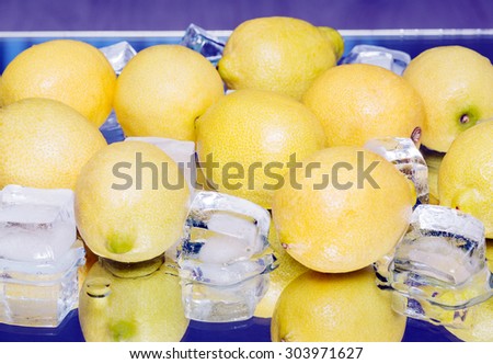 Fresh yellow lemon ice-cooling. mirror reflection. fruit, closeup