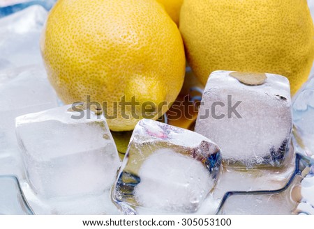 Fresh yellow lemon ice-cooling. mirror reflection. fruit.\
fragment