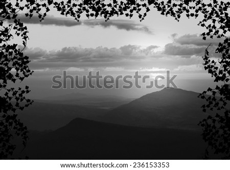Beautiful sunset with cloud and mountain,tree foreground siluette frame,gray color tone