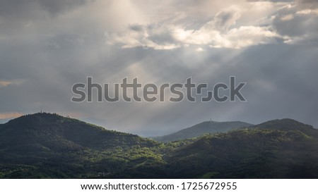 The sun shines thru the clouds during a rain shower over ther Merkur and Fremersberg Mountain near Baden-Baden Germany Stock foto © 