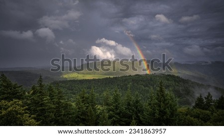 Similar – Image, Stock Photo Thunderstorm over the hill . Only a small bright glow over the blue black rain clouds, the rainforest.  As if the world wanted to end.