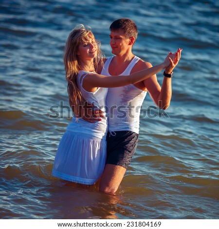Couple in love dancing in the water