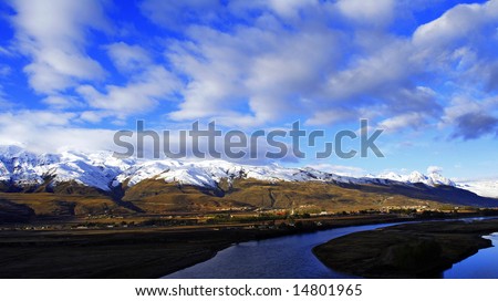 quite snow mountain and withte clouds small river in west China, Ganzi Country,SiChuan Province at morning moment