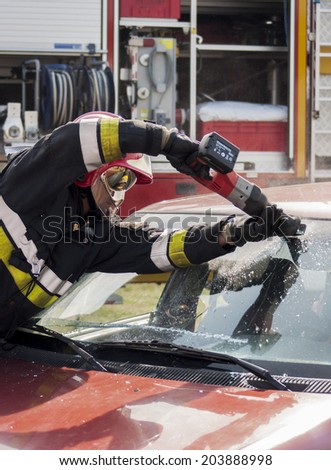SZCZECIN, POLAND - JULY 08, 2014: Fireman in action with Power Wedge at car accident.