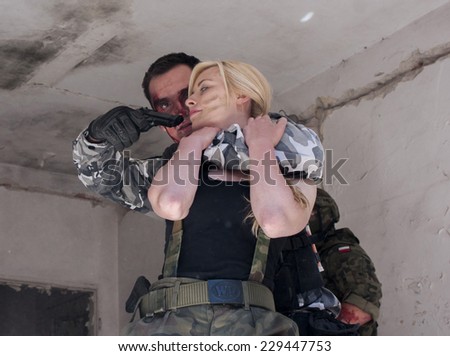 SZCZECIN, POLAND - MAY 31, 2014: female hostage and hijacker with gun, during historical reconstruction