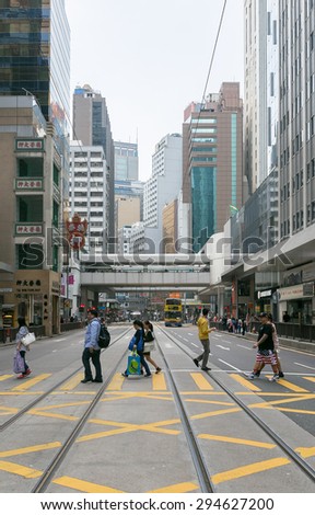 HONG KONG - MAR 29 : Tourists and locals walking across the street on Mar 29,2015 in HONG KONG