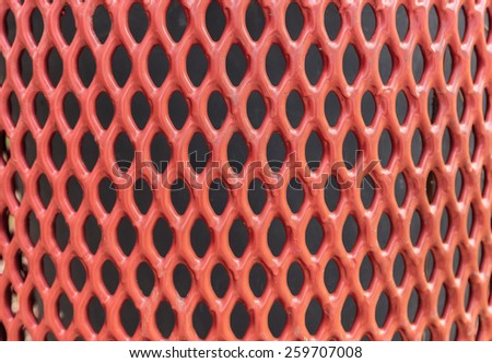 A red fence forms an abstract diamond pattern.