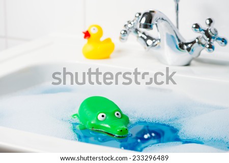 Green rubber crocodile and yellow rubber duck