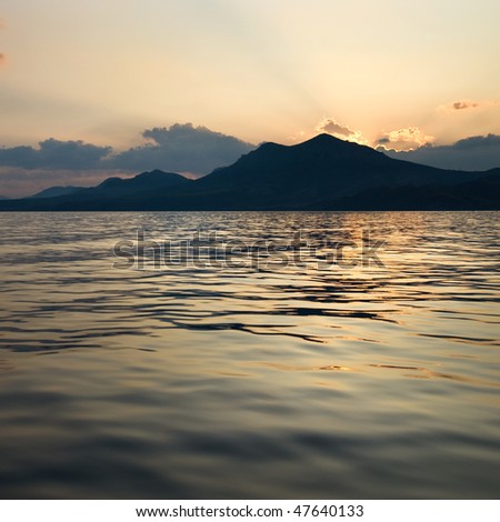 landscape with sea and mountains on sunset