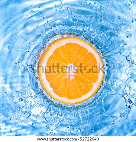 Fresh orange dropped into water with bubbles isolated on white