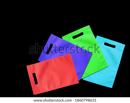 Assorted Color Bags D-Cut Type Non Woven Fabric on Background. Die Cut Gift Bags, Reduce, Reuse, Recycle. Use Me I am not Plastic. ECO Friendly Environment Concoct.   Stok fotoğraf © 