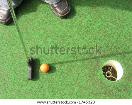 Putting at a mini golf leisure facility.