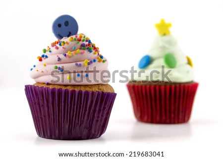 cupcake with pink cream isolated and sprinkles on white background
