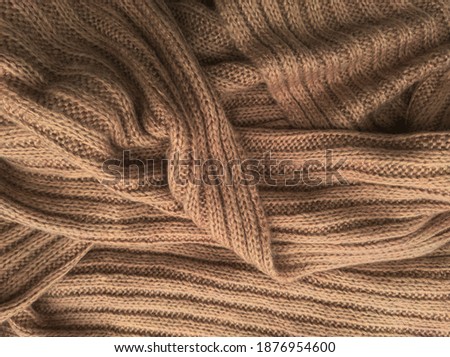 Similar – Image, Stock Photo Brown crumpled knitted scarf or sweater texture, top view. Texture background of warm crocheted clothing textile. Knitwear fabric.