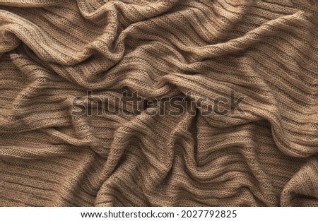 Similar – Image, Stock Photo Brown crumpled knitted scarf or sweater texture, top view. Texture background of warm crocheted clothing textile. Knitwear fabric.