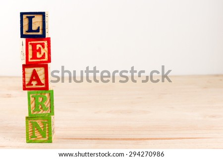 Alphabet Block spell the word learn with copy space.