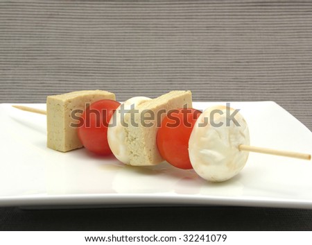 Vegetable spit with bean curd and rice on white plate