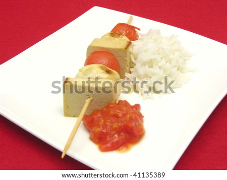 Vegetable spit with bean curd and rice on white plate