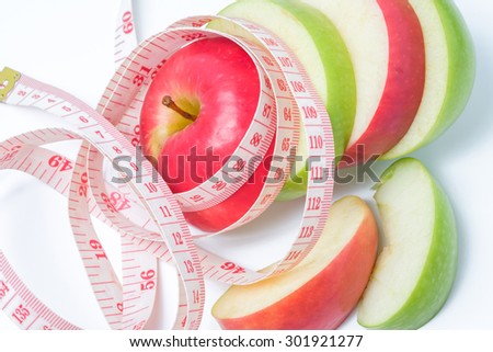 slice red and green apples with waist measure on white background