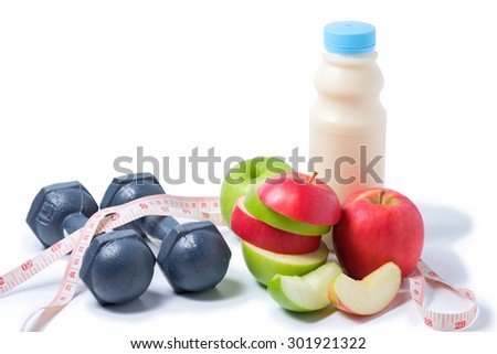 slice red , green apple with dumbbell, waist measure and milk on white background. space for adding your text.