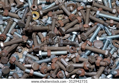closeup of rusted old nut and  bolt in wooden box