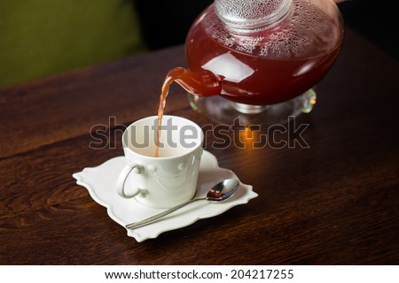 Hot tea with berries on wooden table