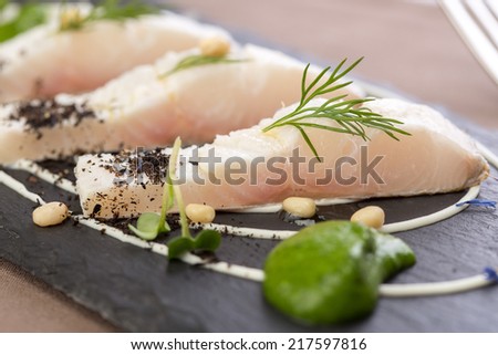 Whitefish fillet served on stone plate. Close up