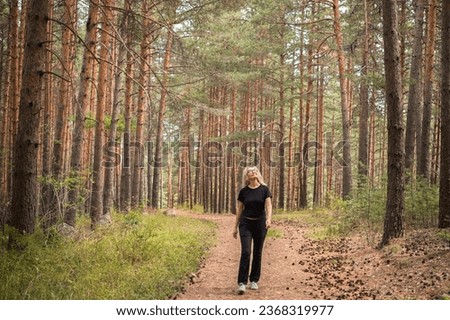 Similar – Image, Stock Photo Walking in the forest. Walk in the forest. Resting on the tree trunk.