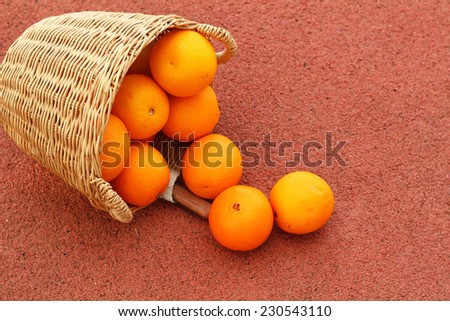 oranges fruits in wicker basket on Rubber floor
