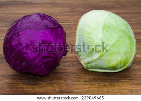 two kinds of cabbage lying on the wooden background
