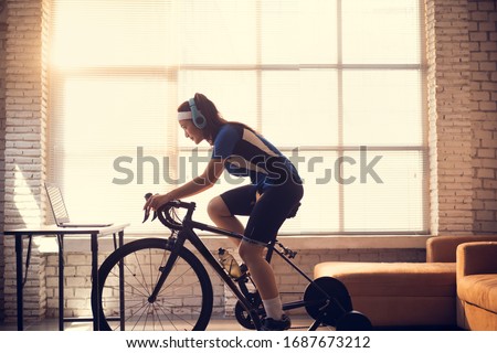 Similar – Image, Stock Photo Female cyclist stretching legs on street