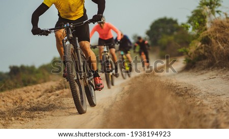 Group of Asian cyclists, they cycle through rural and forest roads.