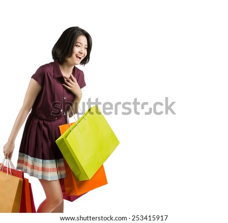 Asian women are astonished and delighted. When she went shopping. She was carrying a bag with multiple colors