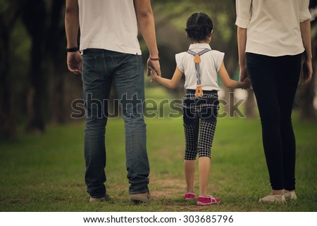 Daughters, parents were holding hands in the park