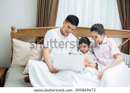 Asian family I was teaching children to use computers They lie on the bed