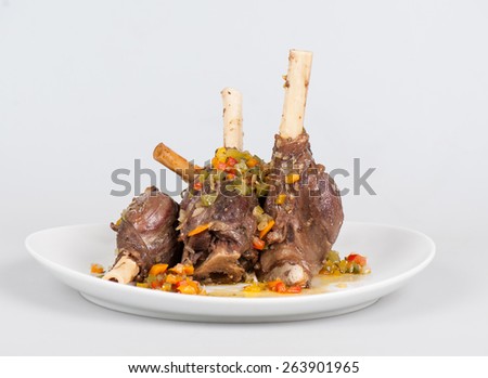 rabbit leg with chopped vegetables in the oven