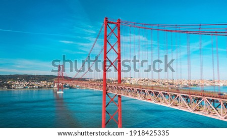 Aerial view or drone photo of the 25 De April Bridge. Red bridge is connecting Lisbon and Almada across the river Tagus. Lisbon and Portugal sightseeing. Foto stock © 