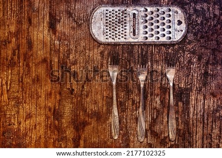 Old metal kitchen utensils. Three stainless steel forks. Rusty kitchen grate against a background of rotting board. Wooden background. Top view. Digital watercolor painting. Contemporary art.