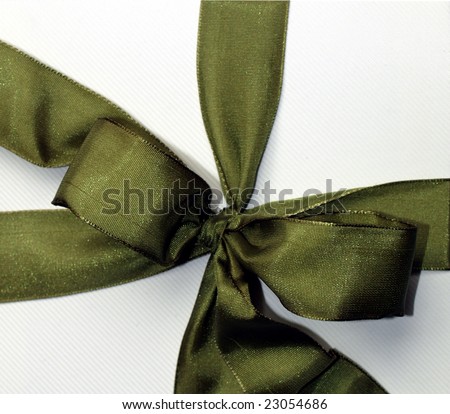 Green ribbon over cardboard box for present