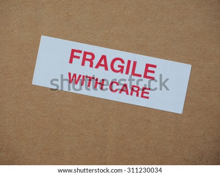 Fragile with care warning sign label tag on a cardboard box packet