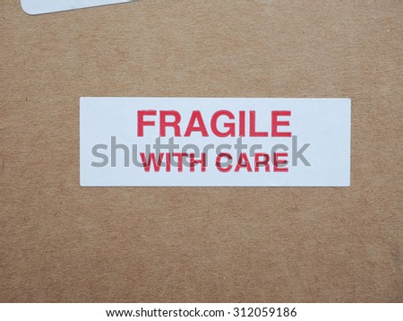 Fragile with care warning sign label tag on a cardboard box packet