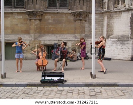 GHENT, BELGIUM - CIRCA JULY 2010: string quartet and accordion performing live in a street of the city centre